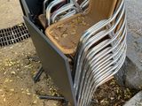 many chairs that are sitting on the side of the street