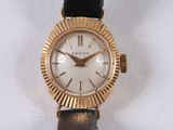 a gold wrist watch with a white face on a black strap