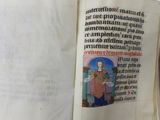 an old book with a picture of a woman holding a baby
