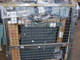 a metal cart with luggage in it in a warehouse