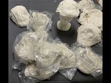 many pieces of paper wrapped in plastic bags on a table