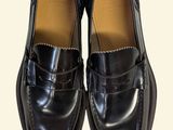 pair of black loafers on a white background with a white background