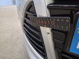 a close up of a car ' s front grill with a ruler on it
