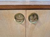a close up of a wooden cabinet with two knobs on it