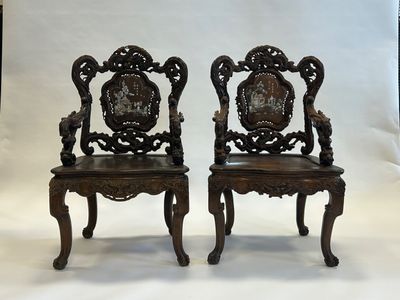 pair of antique carved wood chairs with carved back and arms