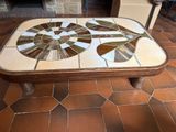 a table with a mosaic design on it in a room