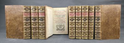 several old books are stacked on top of each other on a table