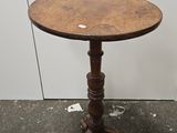 une petite table avec un plateau en bois sur un sol en béton