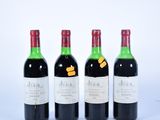 trois bouteilles de vin sont alignées sur une surface blanche