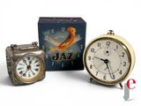 three clocks and a clock box sitting next to each other
