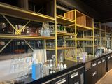 many bottles and glasses on the shelves in the store