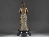 a bronze statue of a woman with a bird on her shoulder
