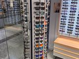a display of sunglasses in a store with a lot of them