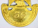 a gold plate with an eagle on top of it