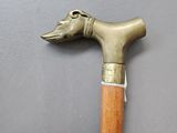 a cane with a dog head on it on a table