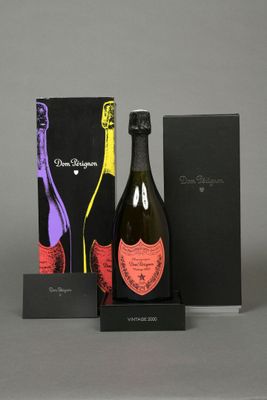 two bottles of champagne and a box of chocolates on a table