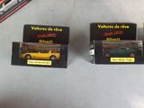 three small boxes of toy cars sitting on a table