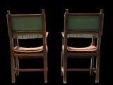 pair of wooden chairs with green upholstered seats against a black background