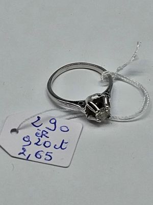 a ring with a tag attached to it on a table