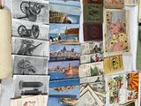 many different types of old postcards on the table