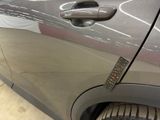 a close up of a car door handle with a sticker on it