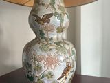 a lamp that is sitting on a table with a bird on it