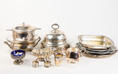 silver plated dishes and silverware on a white surface