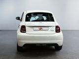 a small white car that is parked in a room