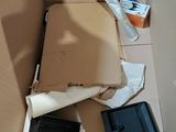 a cardboard box that has a camera and other items in it
