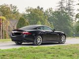 a black sports car driving down the road