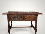 an old wooden table with two drawers on top of it