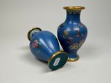 two blue vases sitting next to each other on a table