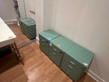 a room with a desk and two filing cabinets in it