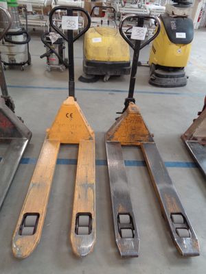four forklifts sitting on the floor in a warehouse