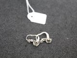 a small pair of earrings that are on a table