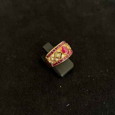 pink and gold ring on a black stand on a black surface