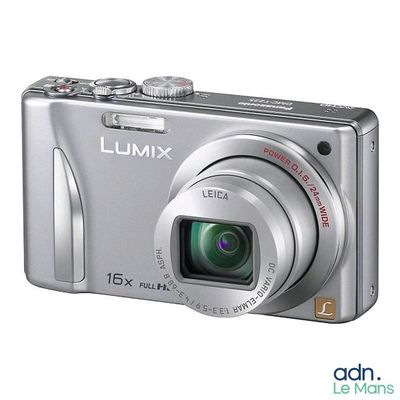 a silver camera that is sitting on a white surface