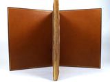 brown leather book with two open pages on a white background