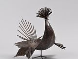 an image of a metal bird statue on a white background