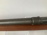 an old gun is on display in a glass case