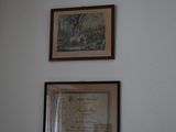 three framed pictures hanging on the wall above a toilet