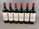 six bottles of red wine lined up in a row