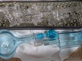 a blue glass bottle and a glass spoon in a box