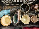 a basket filled with different types of cups and saucers
