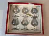 six wine glasses in a red box on a table