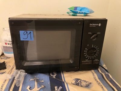a black microwave sitting on top of a table