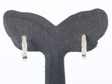 pair of diamond hoop earrings on a black leather stand