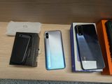 several different cell phones are sitting on a table next to a box