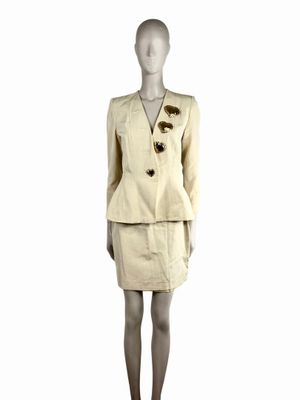 an image of a mannequin dressed in a beige suit and skirt