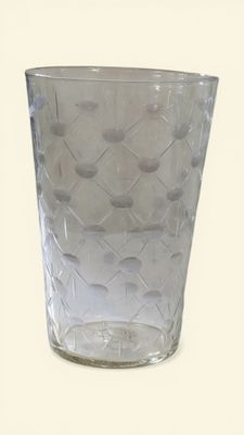 a clear glass with a pattern on it on a white surface